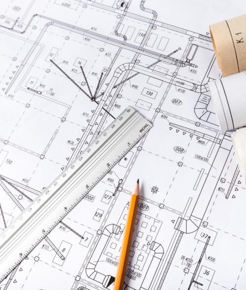 Image of blueprints with a ruler and pencil